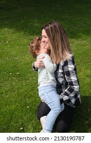 Happy Caucasian Mother And Daughter Playing Hugging In The Garden At Home. Family, Daily Life, Mother's Day