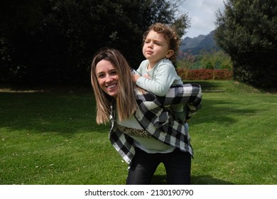 Happy Caucasian Mother And Daughter Playing Hugging In The Garden At Home. Family, Daily Life, Mother's Day