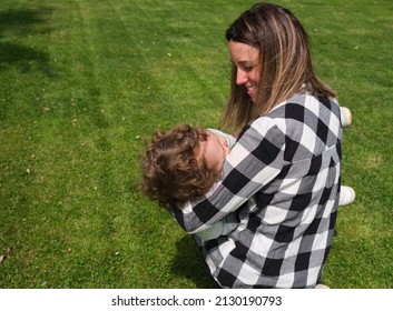 Happy Caucasian Mother And Daughter Playing Hugging In The Garden At Home. Family, Daily Life, Mother's Day