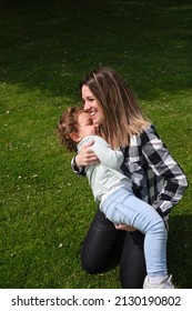 Happy Caucasian Mother And Daughter Playing Hugging In The Garden At Home. Family, Daily Life, Mother's Day