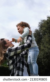 Happy Caucasian Mother And Daughter Playing Hugging In The Garden At Home. Family, Daily Life, Mother's Day