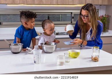 Happy Caucasian Mother With Diverse Kids Cooking, Standing In Modern Kitchen, Two Cute Kids Helping , Multiracial Family Enjoying Weekend