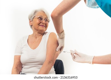 Happy Caucasian Patient Pensioner Lady Getting Anti Coronavirus Vaccine. Prevention Of Viruses Concept. High Quality Photo