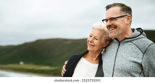 Happy Caucasian senior couple, man and woman, enjoying a scenic coastal view. Senior couple smiling, embracing, enjoying coastal view. Happy elderly couple, coastal view. Senior couple enjoy life - Powered by Shutterstock