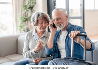 Happy caucasian senior old elderly couple waiting for a taxi to airport train station, travelling and calling on cellphone while ready with bags and baggage at home. Voyage and trip, holidays abroad. - Powered by Shutterstock