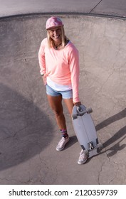 Happy Caucasian Skater Woman Standing In The Skate Bowl