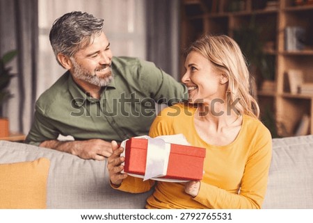 Happy Caucasian Smiling While Preparing For Gift Exchange At Home, Family Concept