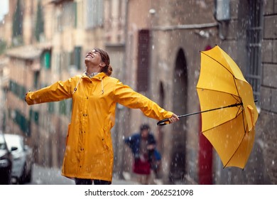 Happy caucasian woman enjoying rainy day in the city - Powered by Shutterstock