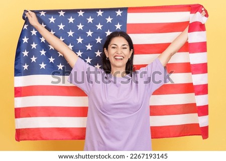 Happy caucasian woman raising a north america national flag