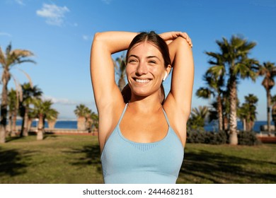 Happy Caucasian woman stretching triceps and warming up before exercising. Female stretching arm preparing to run. Healthy and active lifestyle concept. - Powered by Shutterstock