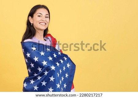 Happy caucasian woman wrapping with a north america national flag