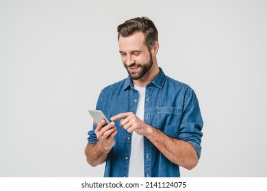 Happy caucasian young man using smart phone cellphone for calls, social media, mobile application online isolated in white background - Shutterstock ID 2141124075