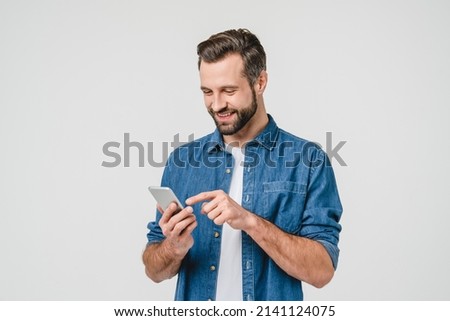 Happy caucasian young man using smart phone cellphone for calls, social media, mobile application online isolated in white background Foto d'archivio © 
