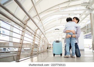 Happy cheerful Asian little boy running to his father at the railway or sky train station after his father returned from the traveling trip. Happy Asian family father and son concept. - Shutterstock ID 2237710111