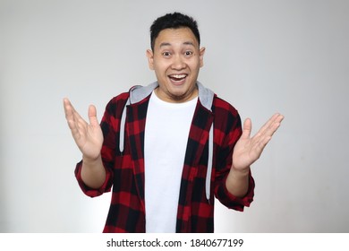 Happy Cheerful Asian Male Smiling At Camera With Hands Raised Up Over Grey Background