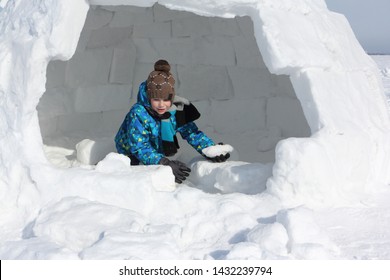 Happy Cheerful Boy Building An Igloo In Winter