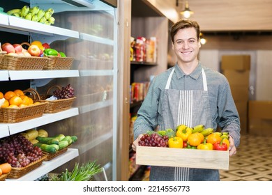 Happy cheerful caucasian grocery store staff arranging a vegetables and fruits on the shelf. Woman staff are working in food and vegetable hypermarket or grocery store. - Powered by Shutterstock