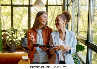 Happy cheerful coworkers chatting at workplace - Powered by Shutterstock