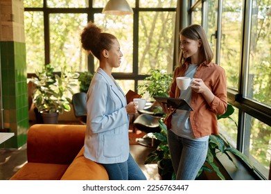 Happy cheerful coworkers chatting at workplace - Shutterstock ID 2256763447