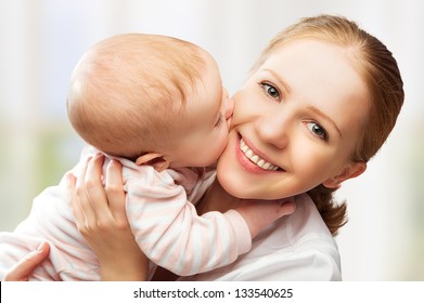 mother kiss baby