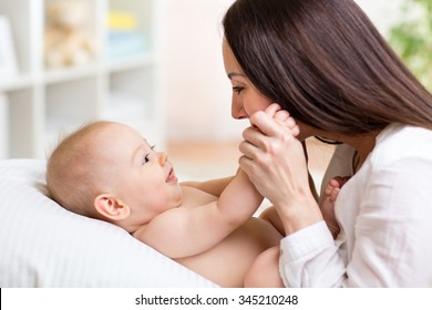 Happy Cheerful Family. Mother And Baby Playing, Laughing And Hugging