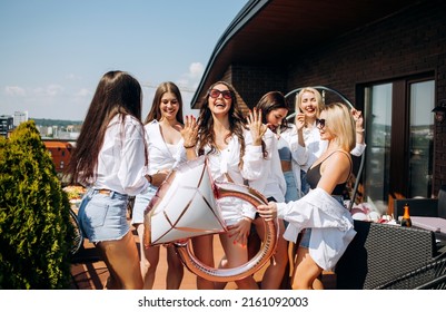 Happy And Cheerful Group Of Women Friends Together Dancing And Having Fun On The Rooftop At Home. Bachelorette Party.