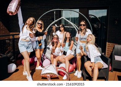 Happy And Cheerful Group Of Women Friends Together Dancing And Drink Champagne On The Rooftop At Home. Bachelorette Party.