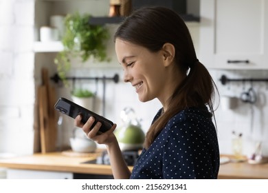 Happy Cheerful Smartphone User Gen Z Girl Talking On Cellphone On Speaker, Using Online Virtual Assistant App, Searching On Internet, Giving Voice Command, Recording Audio Message