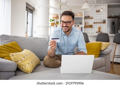 Happy Cheerful Smiling Young Adult Man Doing Online Shopping Or E-shopping Satisfied Entrepreneur Making Online Payment Paying For Service Or Goods Self Employed Freelancer Collecting Fee