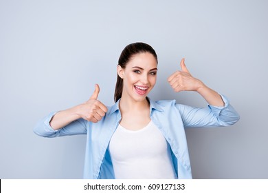 Happy Cheerful Woman In Blue Shirt Showing Thumbs Up  Isolated Gray Background