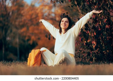 
Happy Cheerful Woman Enjoying Autumn Sitting in the Park.  Carefree lady de-stressing feeling healthy and optimistic
 - Shutterstock ID 2200804405