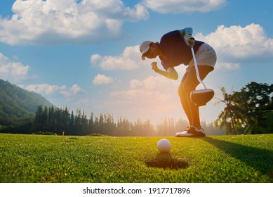 Happy And Cheerful Of The Woman  Golf Player In Winning Putt A Ball Completed Into The Hole On The Green