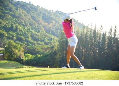 Happy And Cheerful Of The Woman Golf Player In Winning Putt A Ball Completed Into The Hole On The Green