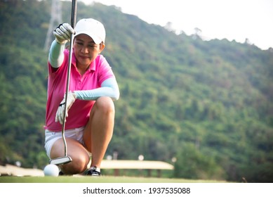 Happy And Cheerful Of The Woman Golf Player In Winning Putt A Ball Completed Into The Hole On The Green