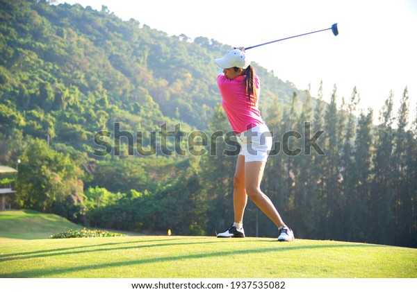 happy and cheerful\
of the woman golf player in winning putt a ball completed into the\
hole on the green