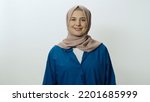 Happy and cheerful young woman in hijab laughing out loud. Woman posing in studio portrait isolated on white background. Portrait showing the feeling of shock or wow in the face of surprise.