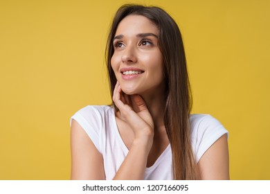 Happy cheerful young woman with joyful and charming smile isolated over yellow background. - Shutterstock ID 1207166095