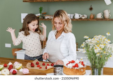 Happy Chef Cook Baker Mom Woman In White Shirt Work With Funny Baby Girl Helper Teach Baking Spread Hand At Kitchen Table Home Cooking Food Process Concept Mommy Little Kid Daughter Prepare Fruit Cake