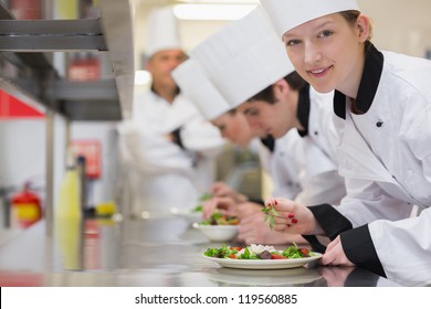 Happy Chef Looking Up From Preparing Salad In Culinary Class