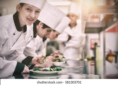 Happy Chef Looking Up From Preparing Salad In Culinary Class