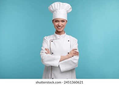 Happy chef in uniform on light blue background - Powered by Shutterstock