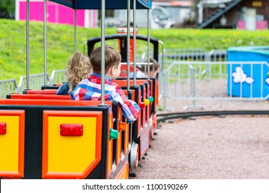 Happy child boy having fun in park. Taking a ride on baby train