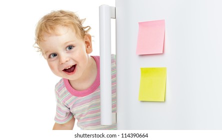 Happy Child Or Boy Hiding Behind Fridge Door