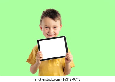 Happy child boy  holding a tablet ipade for your information on the Aqua Menthe background 
