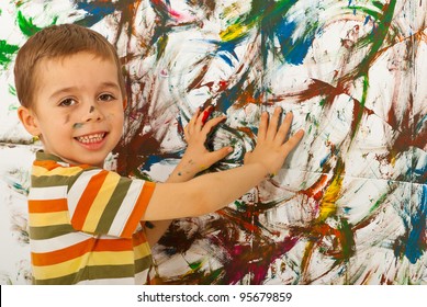 Happy Child Boy Painting A Wall With His Palms