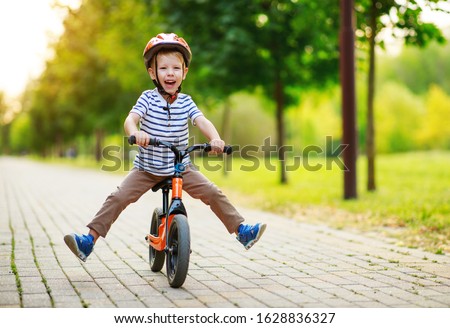 happy child boy rides a racetrack in Park in the summer
