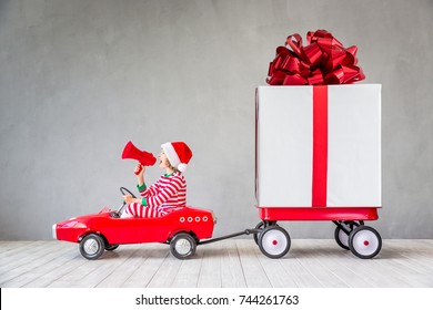 Happy Child With Christmas Gift. Kid Having Fun At Home. Xmas Holiday Concept