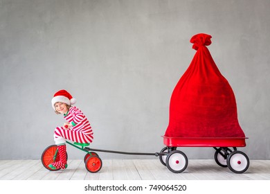 Happy Child With Christmas Gift. Kid Having Fun At Home. Xmas Holiday Concept