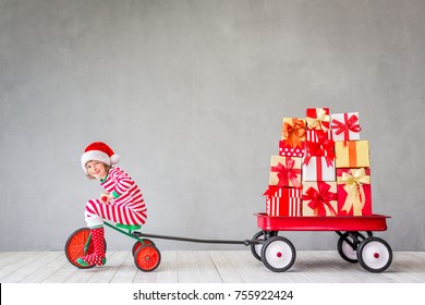 Happy Child With Christmas Gift. Kid Having Fun At Home. Xmas Holiday Concept