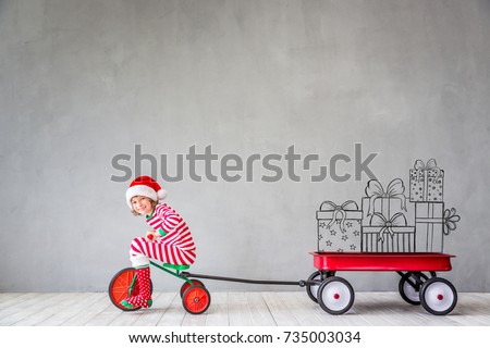 Happy child in Christmas time. Funny kid playing at home. Xmas winter holiday concept